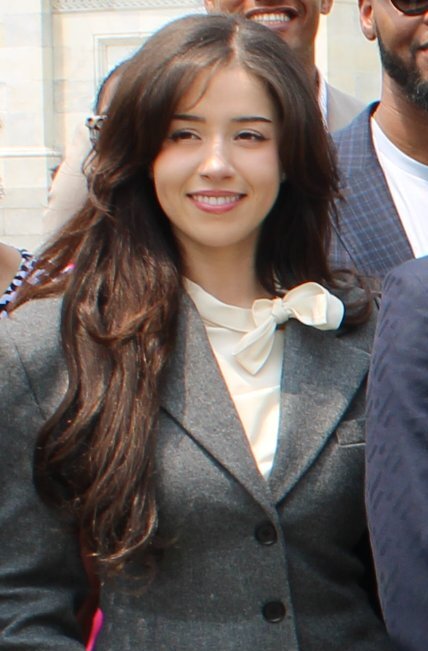 Pokimane smiling in a grey blazer and cream bow blouse at the Creator Economy Caucus launch in the U.S. Congress, June 2025